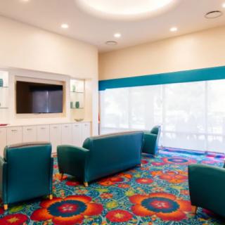 A modern lounge area with colorful carpet and comfortable seating.