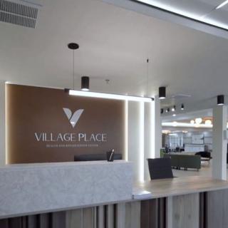 A modern office reception area with a sleek desk and stylish lighting.
