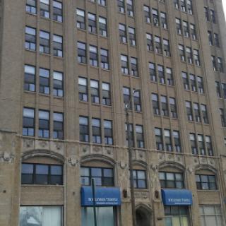 A historic multi-story building showcasing intricate architectural details and numerous windows.