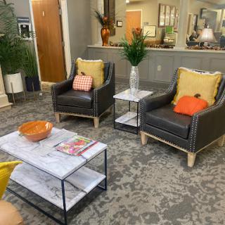 A cozy living area featuring stylish armchairs and a contemporary coffee table.