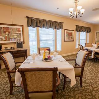 A well-decorated dining room with a set dining table and elegant furnishings.