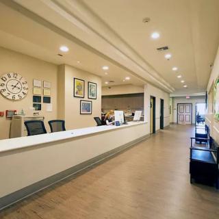 A clean and modern hospital reception area with a spacious corridor.