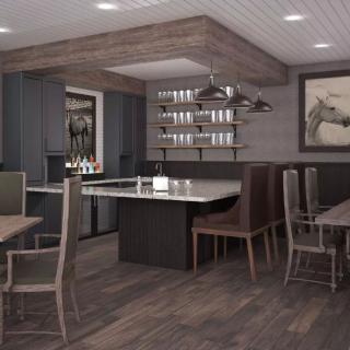 A modern kitchen with a bar counter and dining area, featuring neutral colors and wood accents.