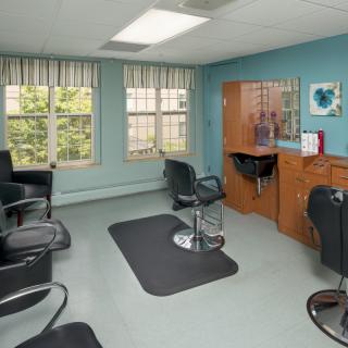 A cozy salon with styling chairs and mirrors.