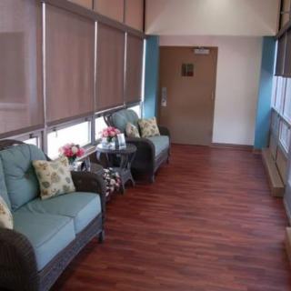 A cozy waiting area with comfortable seating and wooden flooring.