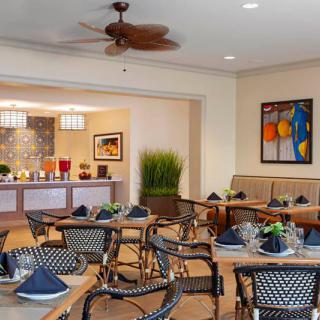 A cozy dining area with neatly arranged tables and chairs, adorned with elegant dcor and artwork.