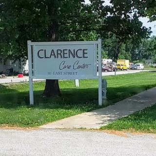 Sign for Clarence Care Center located in a green outdoor setting.