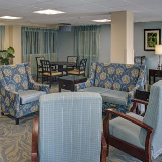 A cozy and modern seating area in a lobby, featuring patterned blue chairs and a welcoming atmosphere.