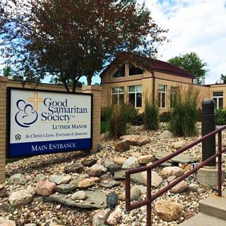 Exterior view of the Good Samaritan Society building with a sign and landscaped entrance.