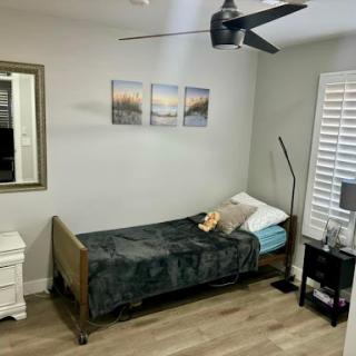 A cozy minimalist bedroom featuring a single bed, stylish decor, and plenty of natural light.