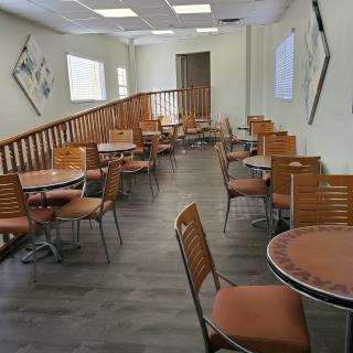 A cozy cafe interior with neatly arranged tables and chairs.