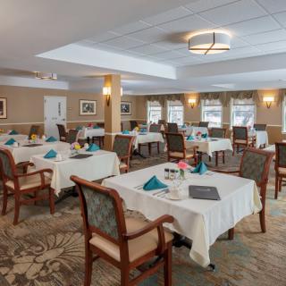 A well-appointed dining room with neatly arranged tables and elegant decor.
