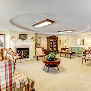 A cozy living room with traditional furnishings and a fireplace.