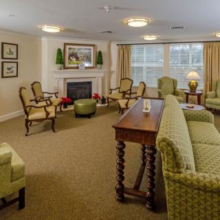 A cozy living room with comfortable seating, a fireplace, and soft lighting.