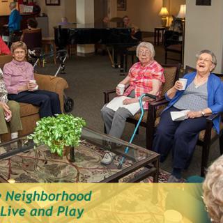 A group of seniors socializing in a comfortable living room setting.