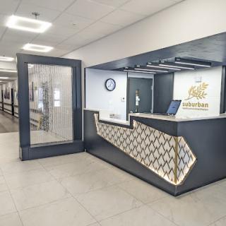 A modern hotel reception area featuring a sleek front desk and contemporary decor.