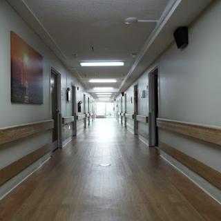 A quiet and well-lit corridor in a hospital, showcasing the clean interior design.