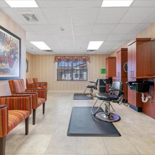 A well-lit salon interior with a waiting area and hair styling stations.