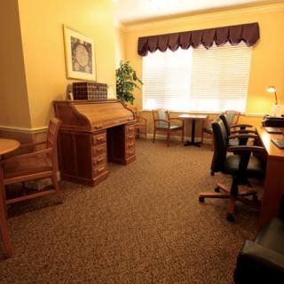A cozy office space with wooden furniture and ample natural light.