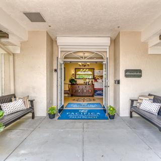 A welcoming entrance featuring benches, plants, and a decorative interior.