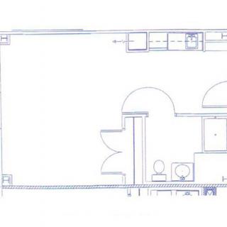 A blueprint layout of a residential or commercial space, displaying rooms and structural elements.