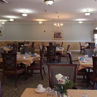 An empty dining room with neatly set tables and chairs.