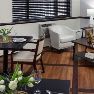 A modern dining room with elegant table settings and comfortable seating.