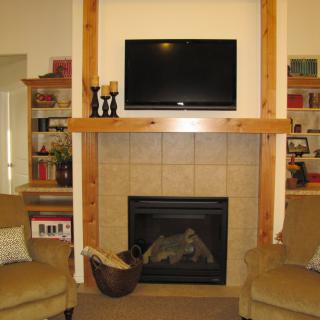 A cozy living room with a fireplace, television, and comfortable seating.