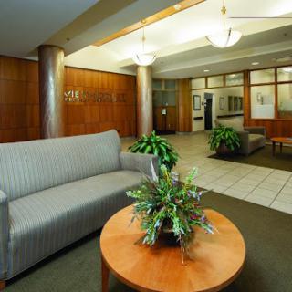 A welcoming lobby area featuring a comfortable sofa and a round table with plants.