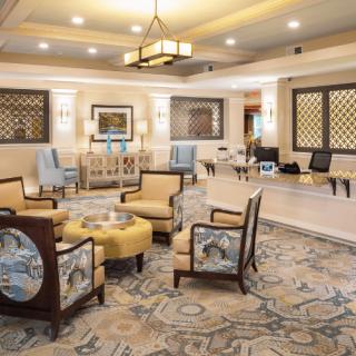 A luxurious hotel lobby with elegant seating and a reception desk.