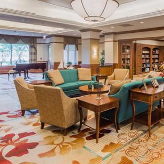 A cozy hotel lobby with comfortable seating and a small library.
