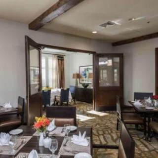A cozy and elegantly decorated dining room with set tables and chairs.