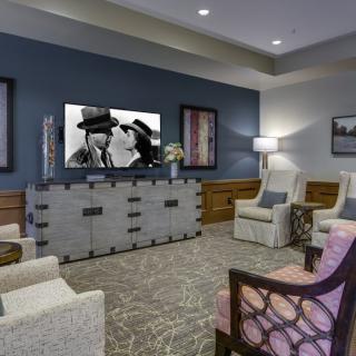 A modern living room with cozy seating, a television, and stylish decor.