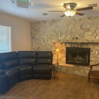 Cozy living room with a stone fireplace and sectional sofa.