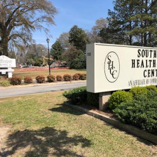 Entrance to Southern Health Center, showcasing the facility's sign amidst a well-kept landscape.