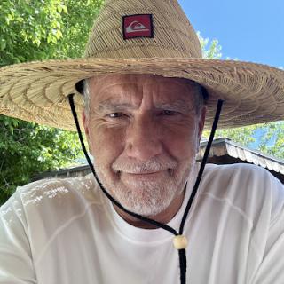 Enjoying a sunny day outdoors with a stylish straw hat.