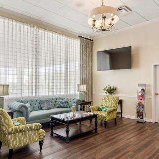 A cozy living room with modern furnishings and a large window.