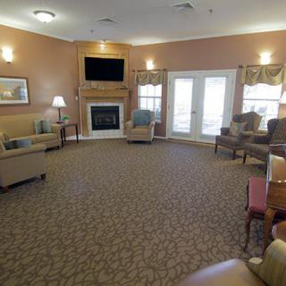 A cozy living room with a fireplace, television, and comfortable seating.
