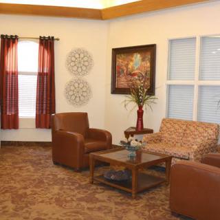 A cozy living room with comfortable seating and decorative elements.