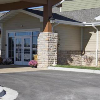 Modern entrance of a commercial building with a driveway.