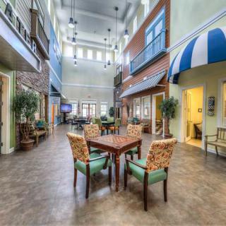 A spacious indoor communal area with seating arrangements and decorative lighting.