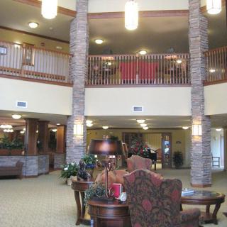 A spacious hotel lobby featuring comfortable seating and elegant lighting fixtures.