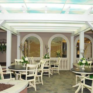 A cozy restaurant interior with neatly arranged tables and elegant floral decorations.