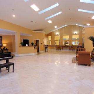 Spacious lobby area with a piano and comfortable seating.