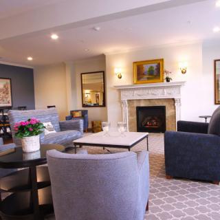 A cozy and modern living room with comfortable seating and a fireplace.