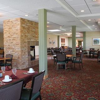 A spacious restaurant dining area with neatly arranged tables and a warm ambiance.