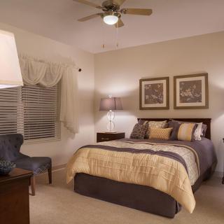 A cozy bedroom with elegant decor and soft lighting.