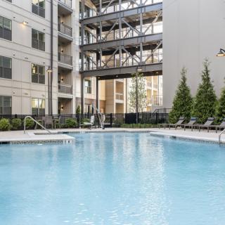 Outdoor pool area in a modern apartment complex.