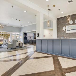A modern lobby area featuring a reception desk, seating, and stylish decor.