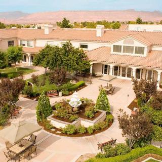 A beautifully landscaped courtyard with a central fountain and seating areas.